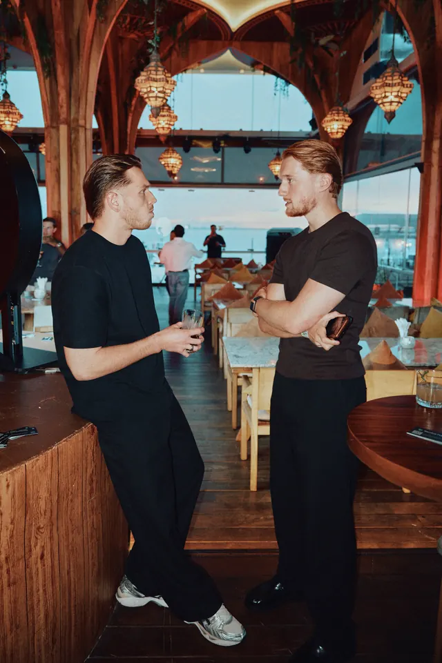 Two AdGuardians team members talking at the venue bar